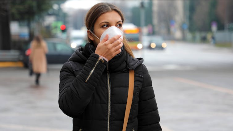 Femme portant un masque dans la rue
