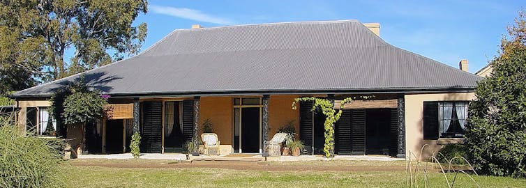 a wide house set on a green lawn