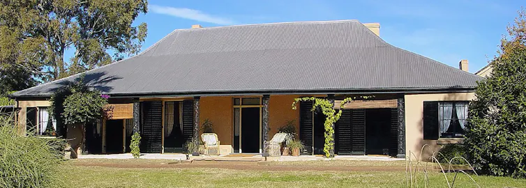 a wide house set on a green lawn