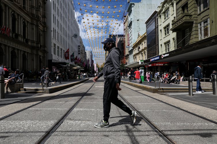 Man walks across the Bourke Street Mall in Melbourne.