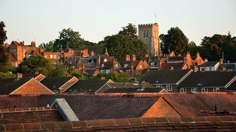 rooftops with church and trees in background