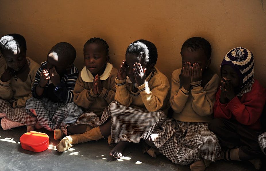 Children praying while seated