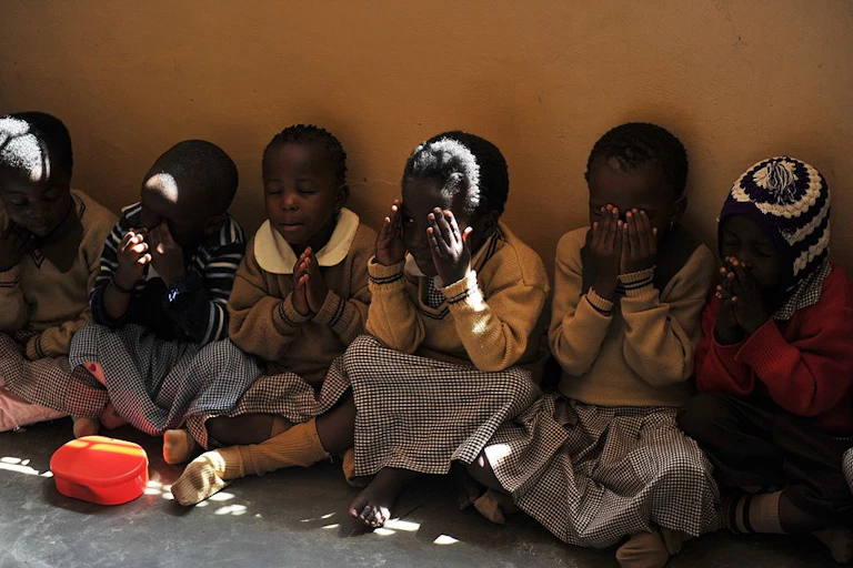 Children praying while seated