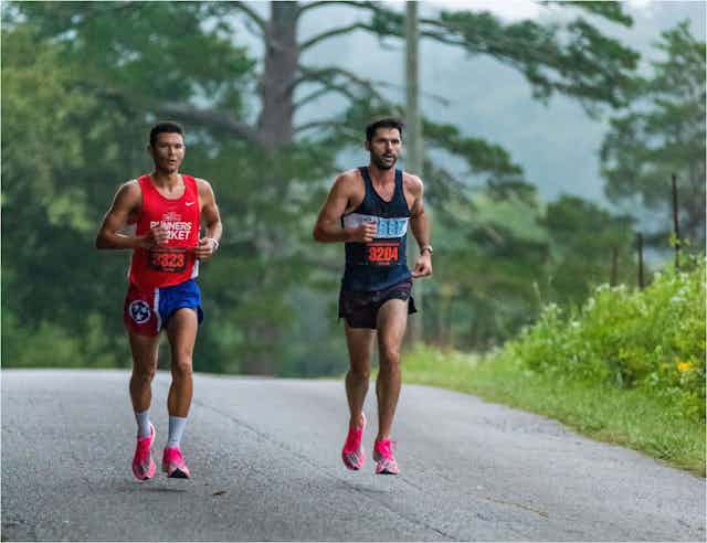 two male runners run a marathon