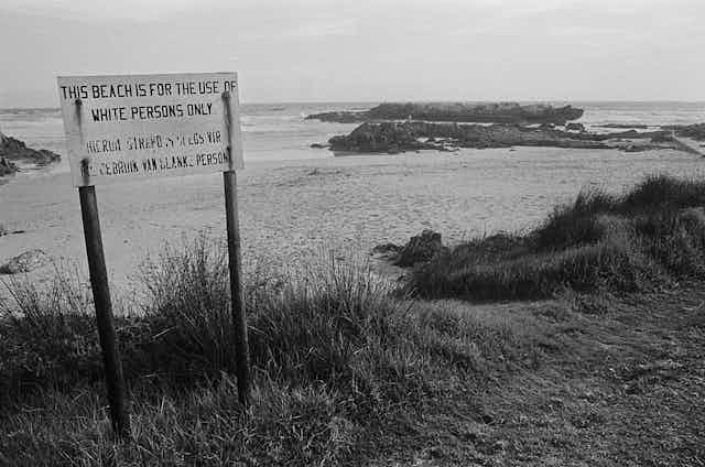 A sign on two poles declares a beach to be for white South Africans only.