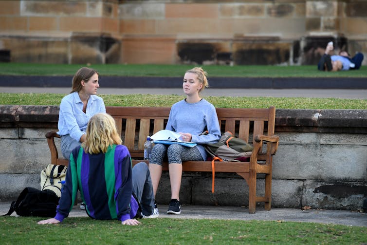 Students sitting on a bench