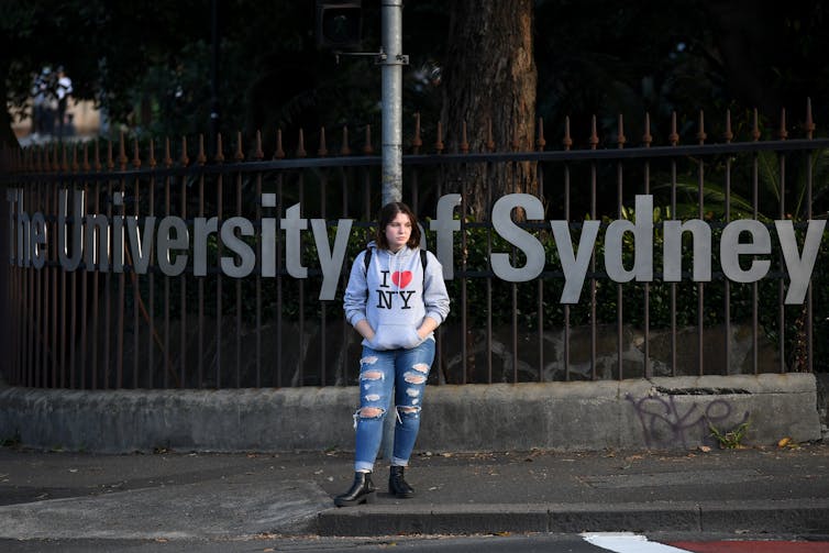 Girl standing in front of University of Sydney sign