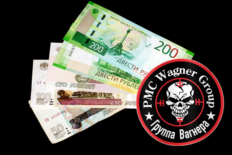 Graphic showing the logo of the Wagner Group with Russian banknotes.