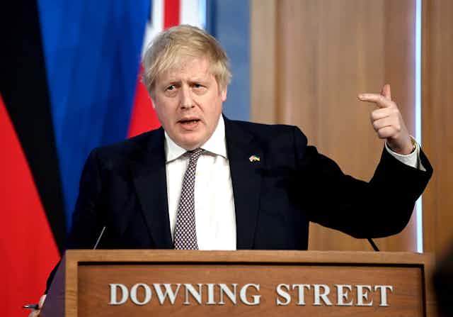 Boris Johnson points at himself during a press conference in Downing Street.