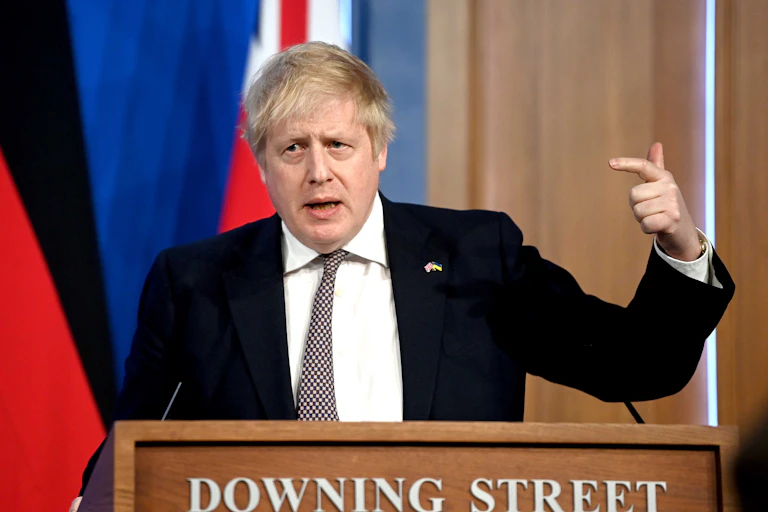 Boris Johnson points at himself during a press conference in Downing Street.