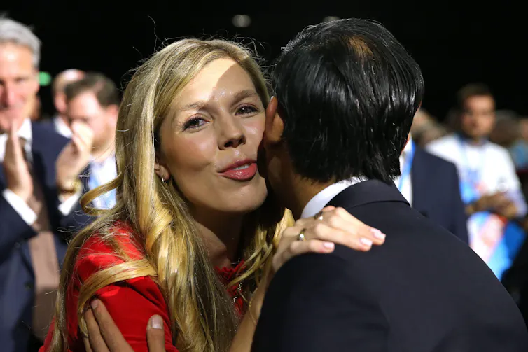 Carrie Johnson kissing Rishi Sunak on the cheek as they greet one another at the Conservative party conference.