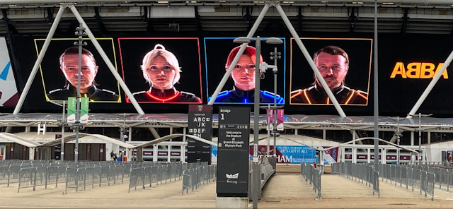 The four avatars of the Abba singers on a hoarding advertising their new show.