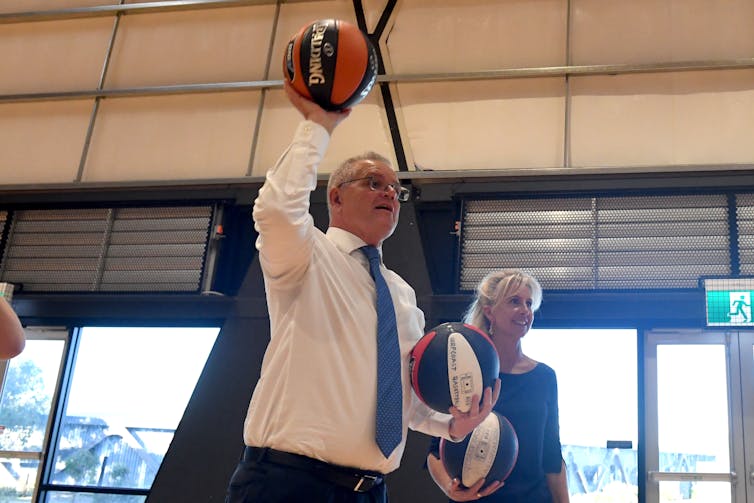 Scott Morrison throwing a basketball.