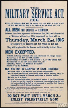 Historical military service act proclamation, white background with blue text reading THE MILITARY SERVICE ACT, 1916, APPLIES TO UNMARRIED MEN WHO, ON AUGUST 15th, 1915, WERE 18 YEARS OF AGE OR OVER AND WHO WILL NOT BE 41 YEARS OF AGE ON MARCH 2nd, 1916.