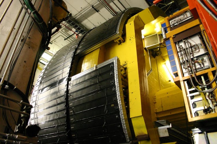 A large yellow tube surrounded by electronics.