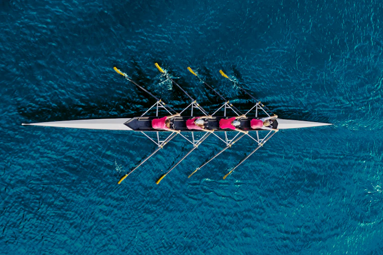 Overhead view of a four people rowing in a canoe