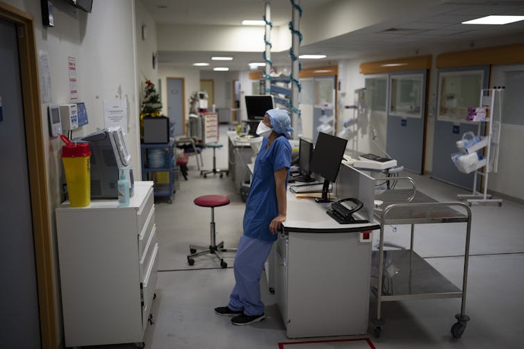 A nurse waits for a blood sample analysis in the COVID-19 intensive care unit.