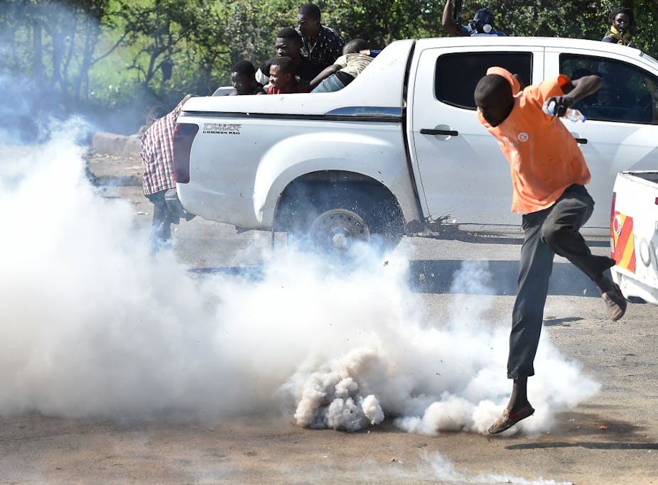 Man jumping away from teargas