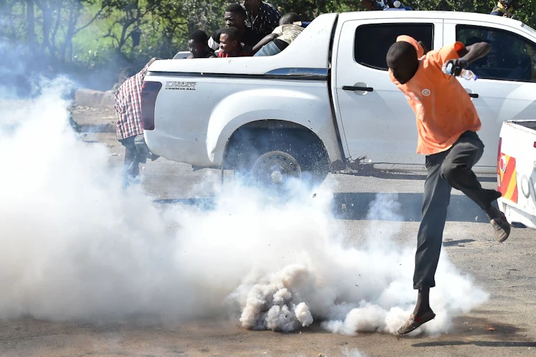 Man jumping away from teargas