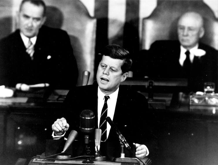 President John F. Kennedy addresses the US Congress in 1961 with Vice President Lyndon Johnson, and (right) Speaker of the House Sam T. Rayburn.