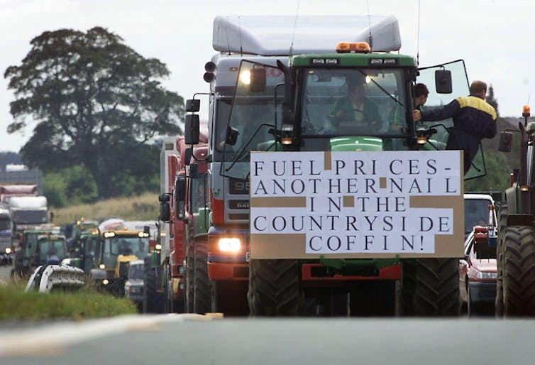 Tractor blocks road with fuel price protest sign
