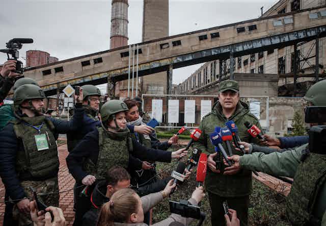The head of the self-proclaimed Luhansk People's Republic, Leonid Pasechnik, talks to journalists. outside the Luhansk Power Station, April 2022.