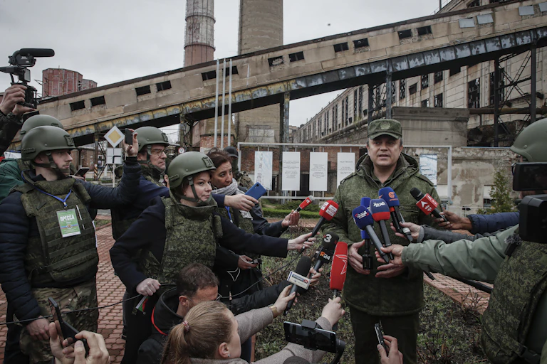 The head of the self-proclaimed Luhansk People's Republic, Leonid Pasechnik, talks to journalists. outside the Luhansk Power Station, April 2022.