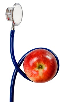 A stethoscope wrapped around an apple.