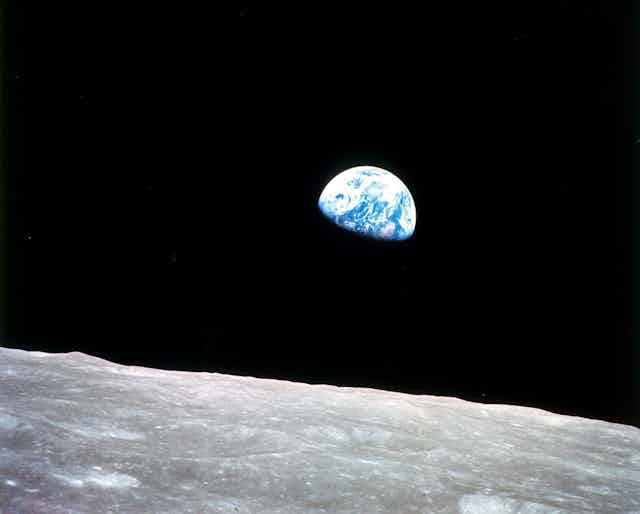 View of Earth with the lunar surface in lower frame