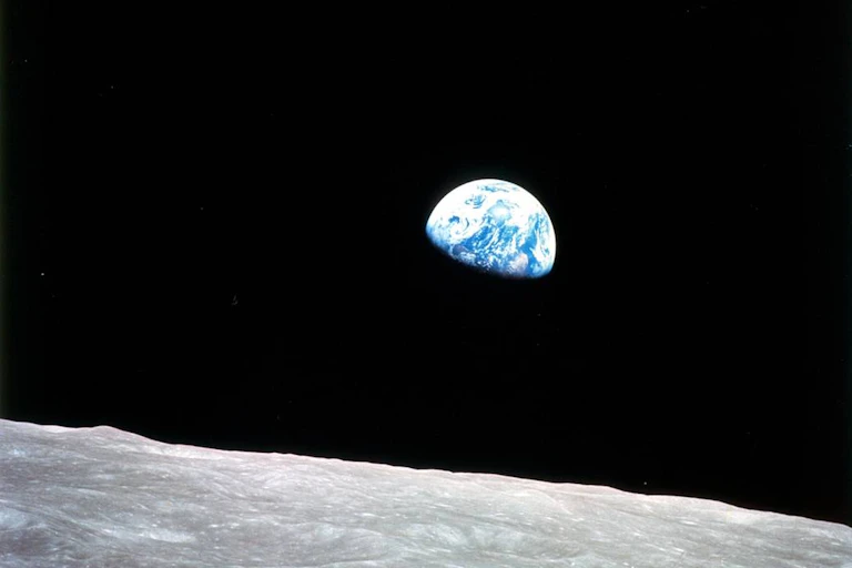 View of Earth with the lunar surface in lower frame