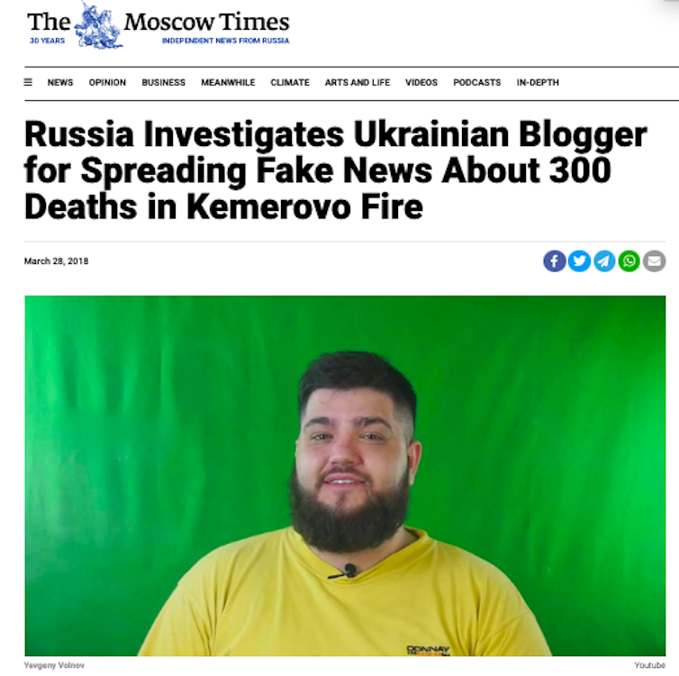 An image of a large bearded young man in a yellow shirt is used to illustrate a Moscow Times story whose headline is 'Russia Investigates Ukrainian Blogger for Spreading Fake News About 300 Deaths in Kemerovo Fire.'