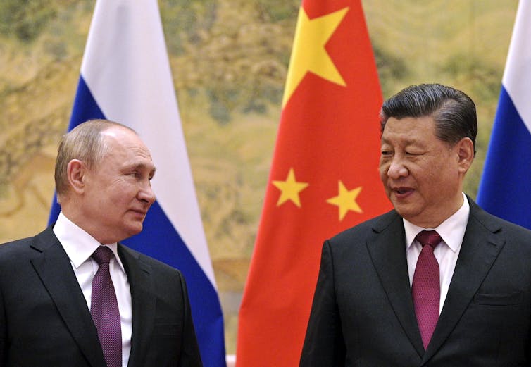 Russian President Vladimir Putin and PRC leader Xi Jinping standing meeting in Beijing