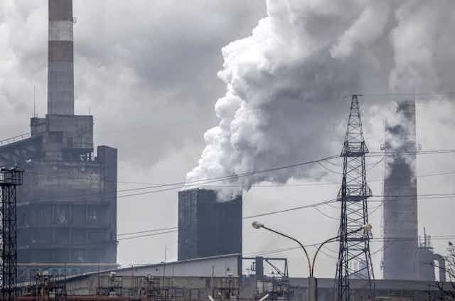 Smoking pouring from industrial buildings.