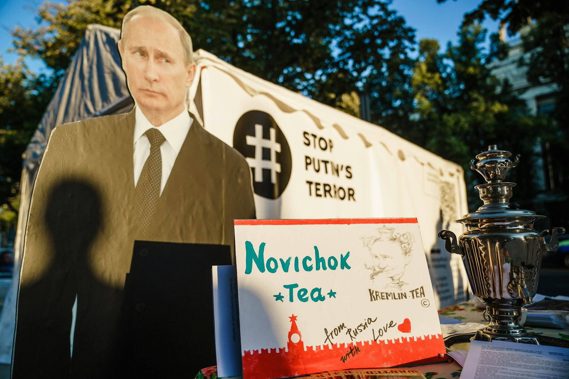 Posters showing Russian President Vladimir Putin and a teapot, with text reading 'Stop Putin's Terror' and 'Novichok Tea'