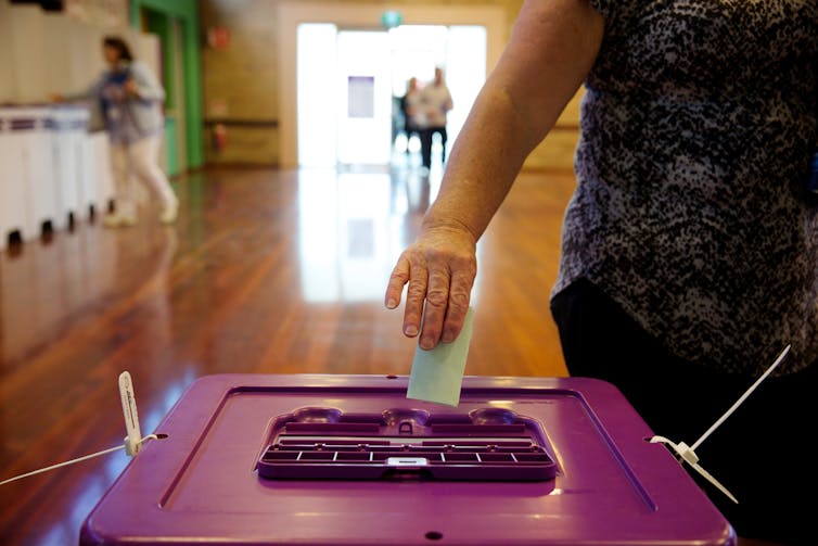 Woman casts a ballot for the lower house.