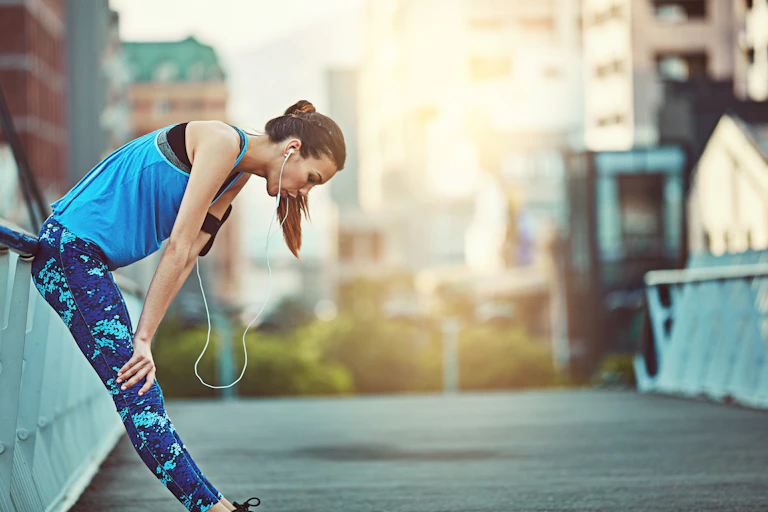 Woman stopping for a breath while running