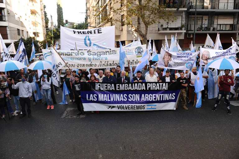 March in Buenos Aires for the 40th anniversary of the Falklands War, marchers hold up a sign sying 'The Malvinas are Argentinian'