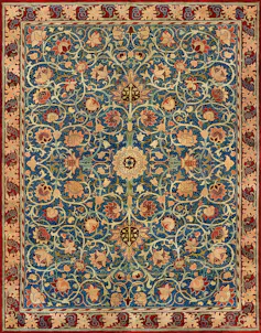 A carpet with an orange, burgundy and rust floral design over a teal background with a circular centre.