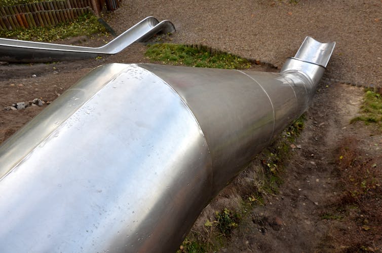 Looking down on a stainless steel tube slide.