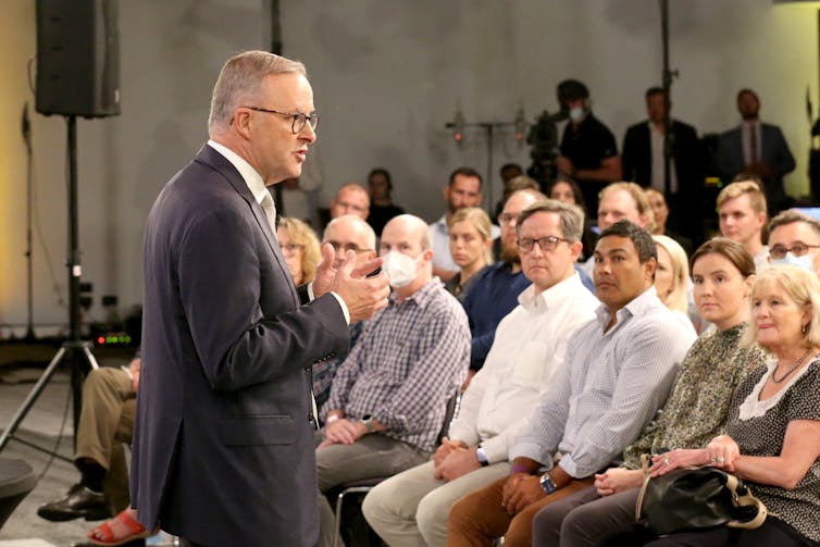 Albanese in front of the debate audience.