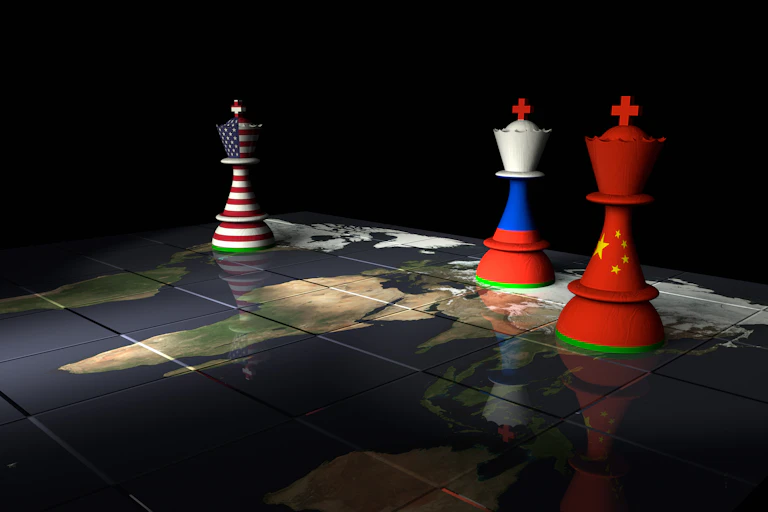 A U.S. flag chess piece on a map across from Russian and Chinese chess pieces.