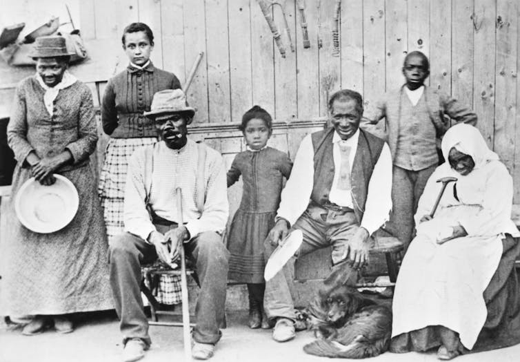 A group of Black men and women are posing for a portrait.