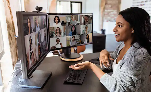 A woman on a video call with man other people.