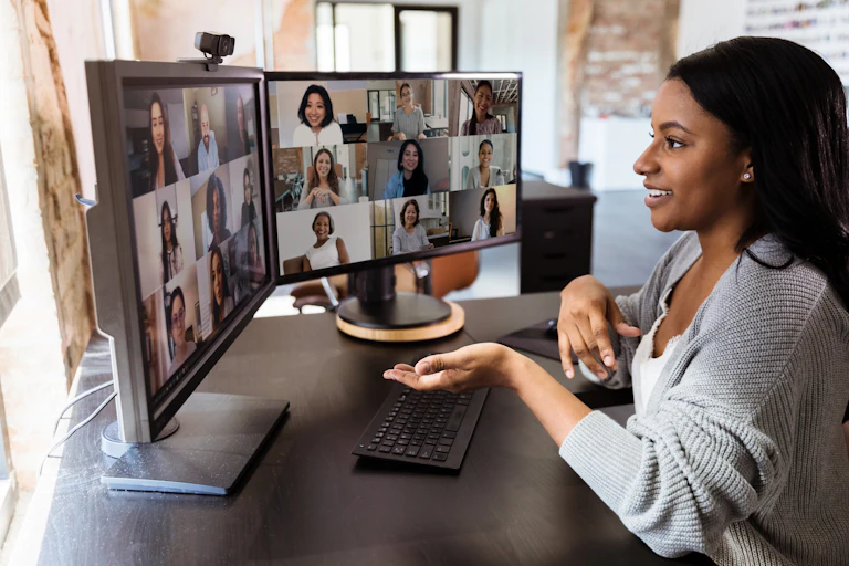 A woman on a video call with man other people.