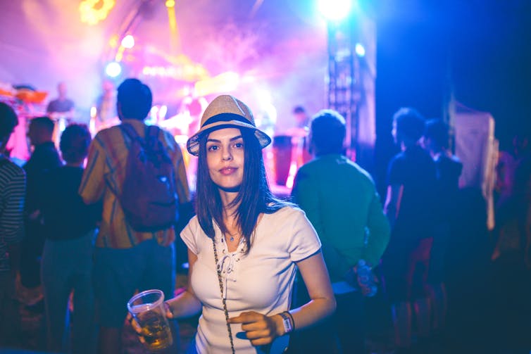 A woman in a t-shirt at night at a party.