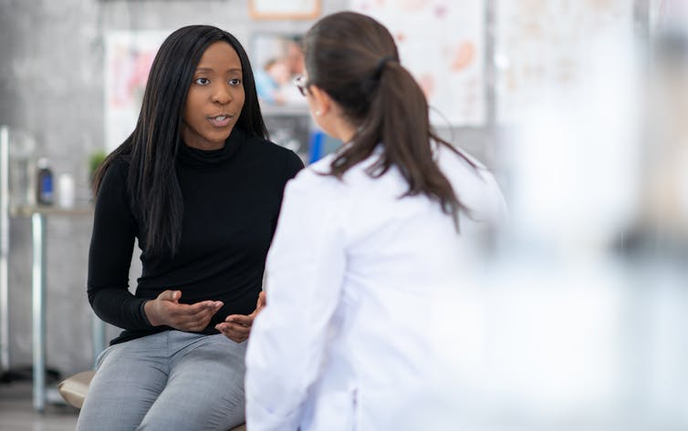 Person talking to doctor in exam room