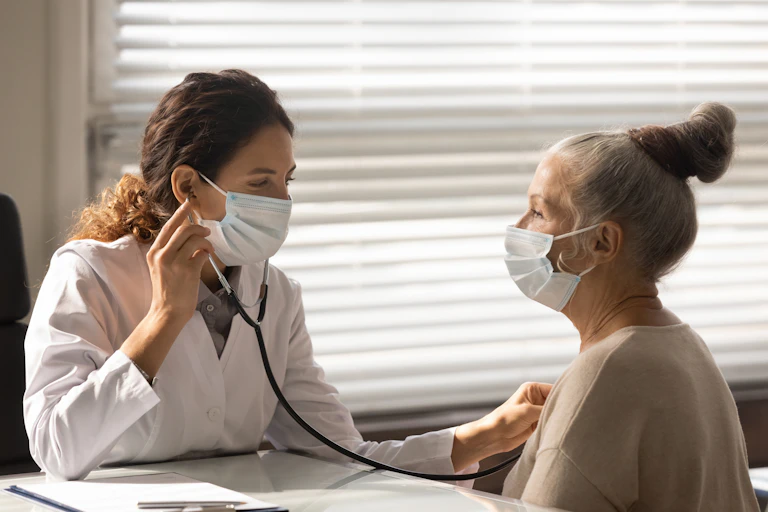 Doctor with a stethoscope to patient