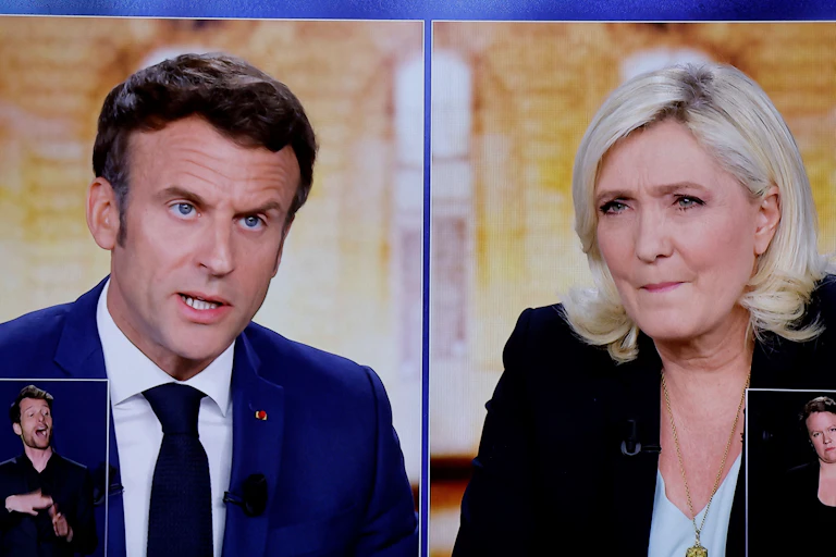 Une photo montre des écrans affichant un débat télévisé en direct entre le président français et candidat à la réélection dEmmanuel Macron et la candidate à la présidence Marine Le Pen, le 21 avril 2022.