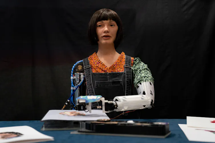 A humanoid robot in overalls.
