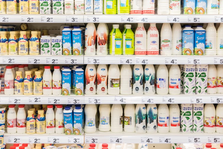 Supermarket shelf showing soy and other milk products.
